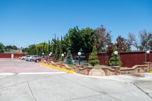 a parking lot with a park with cars parked at Motel 7 - Near Six Flags, Vallejo - Napa Valley in Vallejo