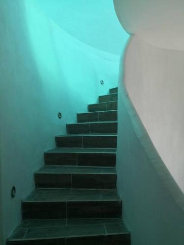 a stairway with black steps and a white wall at Blessed Rest Home Teques in Tequesquitengo