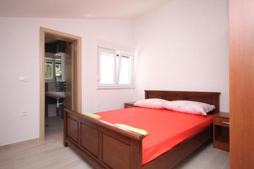 a bedroom with a bed with two pillows on it at Apartments by the sea Basina, Hvar - 8754 in Vrbanj