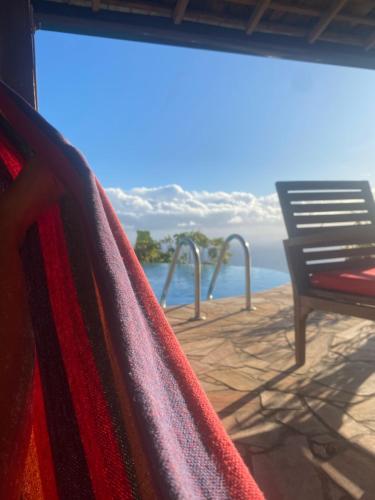 a view of the ocean from a hammock on a deck at Globe trotter Lodge Tahiti in Punaauia