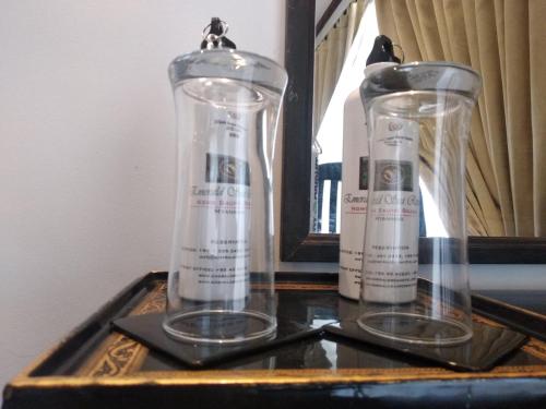 two glass vases sitting on top of a table at Emerald Sea Resort in Ngwesaung
