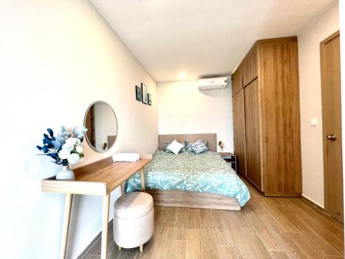 Ένα ή περισσότερα κρεβάτια σε δωμάτιο στο Milan Homestay - The Song Vung Tau Apartment