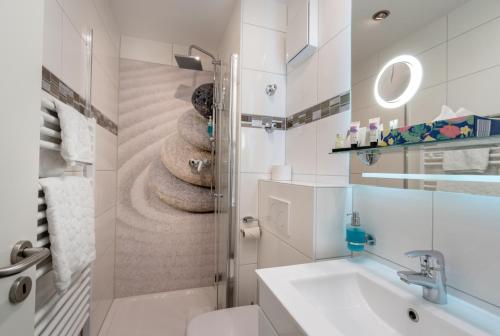 a white bathroom with a sink and a toilet at Hotel Stadt Heidelberg in Darmstadt