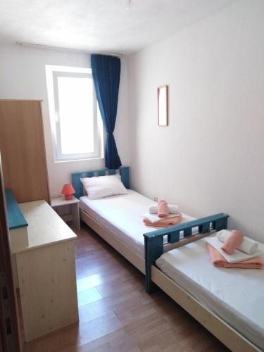 a room with two beds and a window at Apartments with parking space Stanici, Omis - 10360 in Čelina
