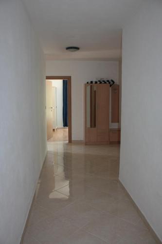 an empty room with white walls and a tile floor at Apartments with parking space Stanici, Omis - 10360 in Čelina