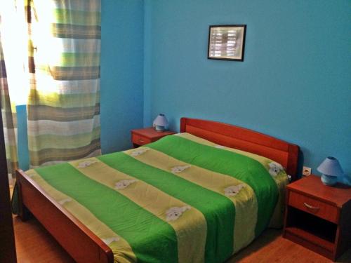 a bedroom with a bed with a green blanket at Seaside holiday house Brna, Korcula - 11038 in Smokvica