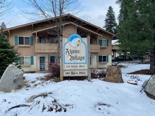 a sign in the snow in front of a building at Walk to Downtown Leavenworth * Sleeps 6 + Pets * Ground Level Gem! in Leavenworth