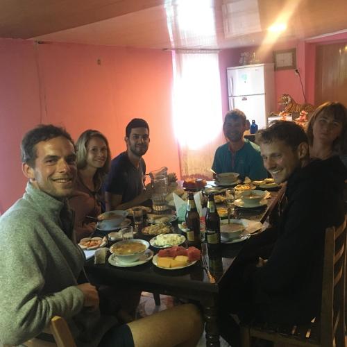 a group of people sitting around a table eating food at Sweet home in Lalkhori