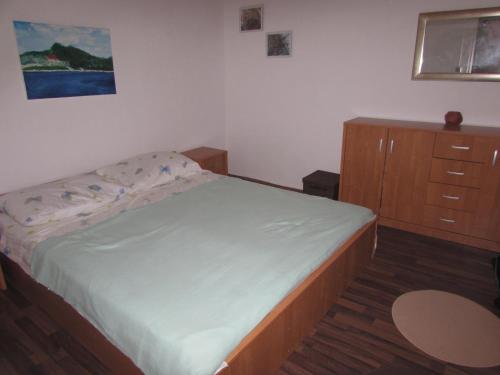 a small bedroom with a bed and a dresser at Seaside secluded apartments Cove Krsovica - Telascica, Dugi otok - 11001 in Sali