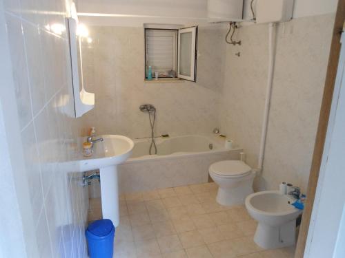 a bathroom with a tub and a toilet and a sink at Apartments by the sea Sobra, Mljet - 11011 in Sobra