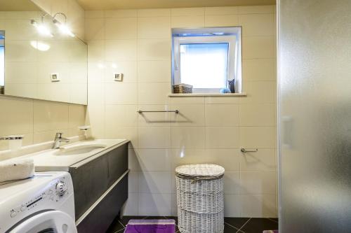 a bathroom with a sink and a washing machine at Luxury villa with a swimming pool Dubravka, Dubrovnik - 11073 in Gruda