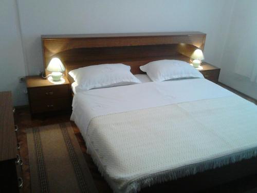 sypialnia z dużym białym łóżkiem z 2 lampami w obiekcie Apartments with a parking space Maslenica, Novigrad - 11089 w mieście Maslenica