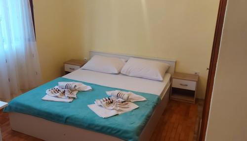 a bedroom with a bed with towels on it at Rooms with a parking space Selce, Crikvenica - 11133 in Selce
