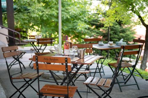 an outdoor table and chairs with glasses on it at Hotel Panoramic in Râmnicu Vâlcea