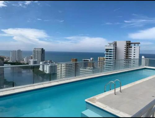 a swimming pool on the roof of a building at lovely 2 bedroom Apartment with pool and gym in Cartagena de Indias