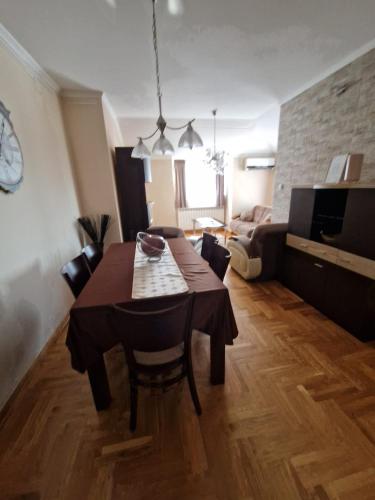 a living room with a dining table and a living room with a couch at Danube duplex apartment in Smederevo