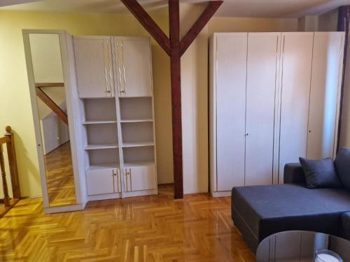 a living room with a couch and white cabinets at Danube duplex apartment in Smederevo