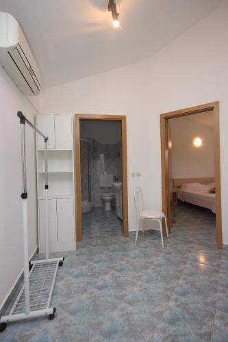 a room with a treadmill and a bathroom with a toilet at Family friendly seaside apartments Preko - Ugljan - 8232 in Poljana