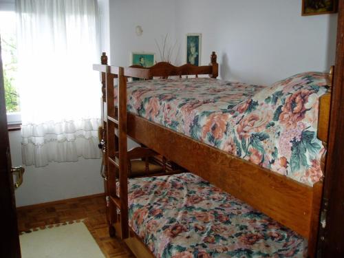 1 dormitorio con 2 literas y colcha de flores en Seaside holiday house Starigrad, Paklenica - 11240, en Starigrad-Paklenica