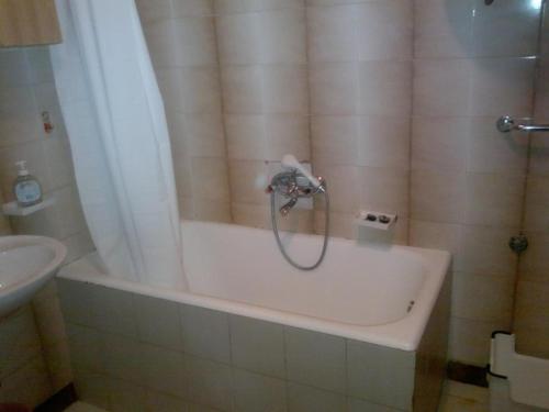 a bath tub with a shower head in a bathroom at Apartments by the sea Martinscica, Cres - 11279 in Martinšćica