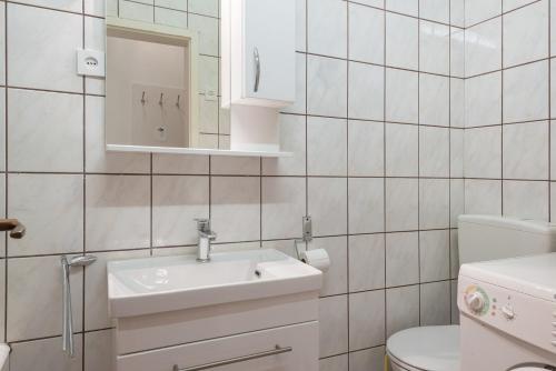 a white bathroom with a sink and a toilet at Apartment Jelsa 11319a in Jelsa