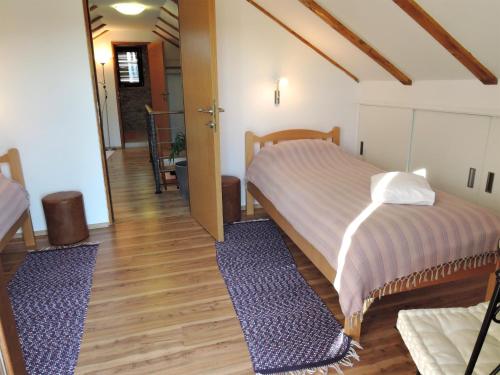 um quarto com 2 camas e piso em madeira em Family friendly house with a swimming pool Gluici, Krka - 11337 em Validžići