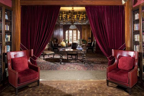 a living room with red chairs and a chandelier at Los Angeles Athletic Club in Los Angeles