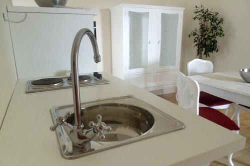 a kitchen sink with a faucet on a counter at Apartments with a swimming pool Zagreb - 11408 in Zagreb