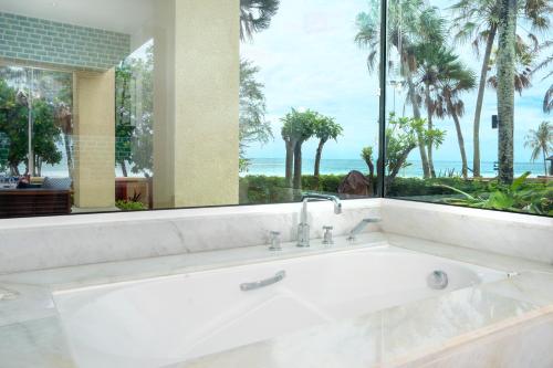 a white bath tub with a view of the ocean at Karon Sea View Beach Apartment in Karon Beach