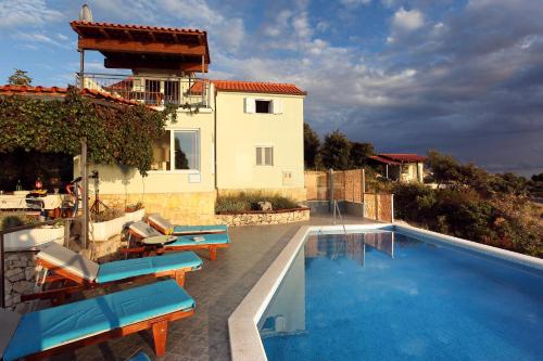 una villa con piscina e una casa di Holiday Home Kanica 10367 a Rogoznica (Rogosnizza)