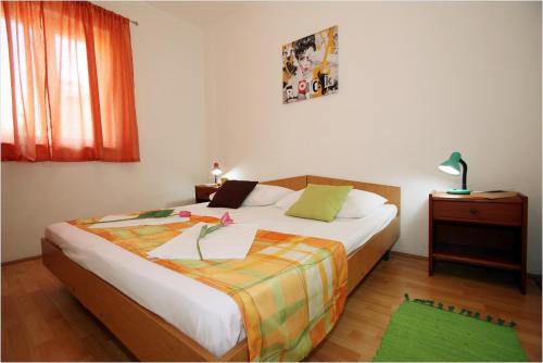 - une chambre avec un lit et une couverture colorée dans l'établissement Apartments with a parking space Supetar, Brac - 11147, à Supetar