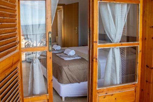 a bedroom with a bed with two bunk beds at Apartmets Flisvos in Kalyves