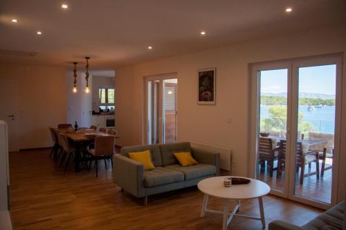 ein Wohnzimmer mit einem Sofa und einem Tisch in der Unterkunft Vila Casa di mare Jelsa, otok Hvar in Jelsa