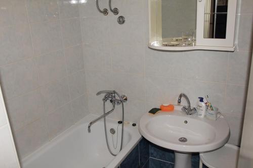 a bathroom with a sink and a bath tub and a sink at Rooms by the sea Makarska - 11096 in Makarska