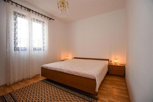a bedroom with a bed and a window at Apartments with a parking space Pag - 11358 in Pag