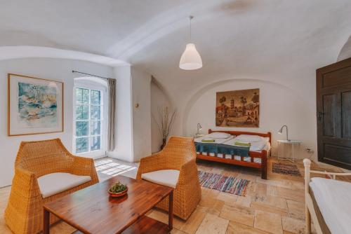 a living room with a bed and a table and chairs at Óbester Panzió in Badacsonytomaj