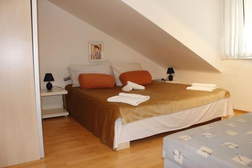 a bedroom with a bed with an attic at Apartments with a parking space Novalja, Pag - 6432 in Novalja