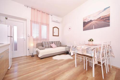 a living room with a table and a couch at Apartments by the sea Tkon, Pasman - 8414 in Tkon