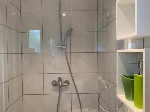 a shower with a glass door in a bathroom at Modern Apartment in Arnoldstein with Garden in Arnoldstein