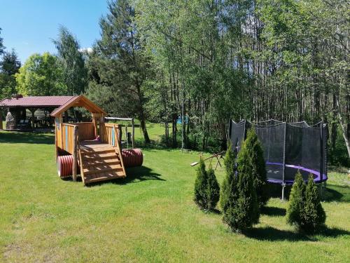 a playground in a park with a slide at Kasztanowe Wrota in Kosewo