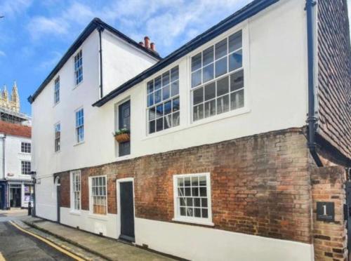 a brick and white building on a street at Turnagain Lane, Canterbury City Centre in Canterbury