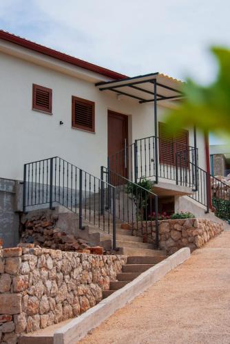 a house with stairs and a stone wall at Vila Casa di mare Jelsa, otok Hvar in Jelsa