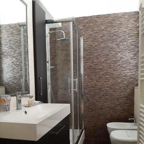 a bathroom with a sink and a toilet and a shower at Dimora dAmare in Trani