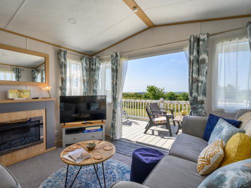 a living room with a couch and a television at Rose View in Newquay
