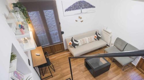 a living room with a couch and a table at The Magic Place Dúplex junto a la Catedral by Toledo AP in Toledo
