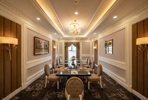 a conference room with a long table and chairs at Muong Thanh Luxury Saigon Hotel in Ho Chi Minh City