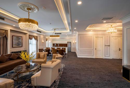 a lobby with couches and chairs and a table at Muong Thanh Luxury Saigon Hotel in Ho Chi Minh City