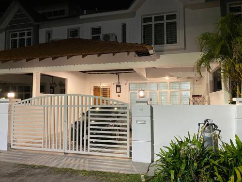 a white fence in front of a house at 28 Residence Homestay in Melaka