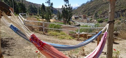 a hammock with a view of a valley at Ecolodge Casa del Montañista in Huaraz