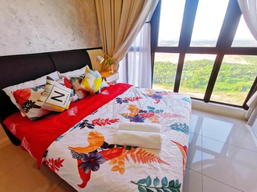 a bedroom with a bed with a colorful quilt and a window at Legoland 3min Lakeview HappyRainbowSuite 7Pax 2R2B in Nusajaya